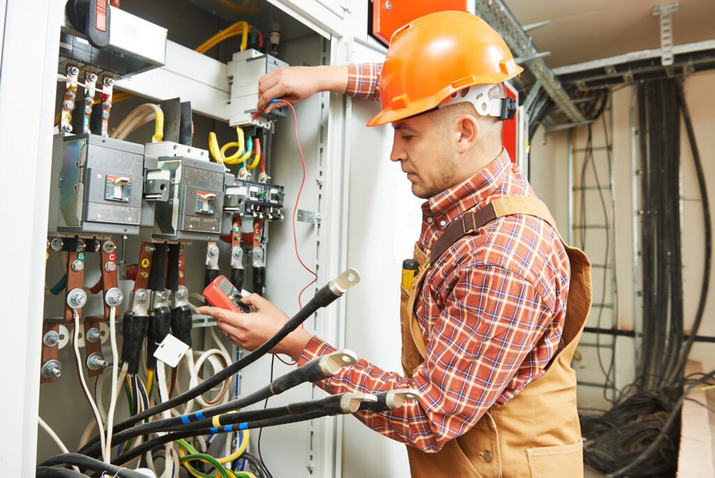 A view of an electrician repairing outlets and wiring