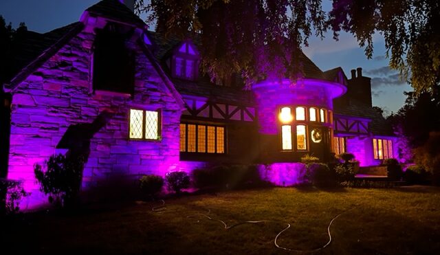 A view of the exteriors of a property with purple lighting