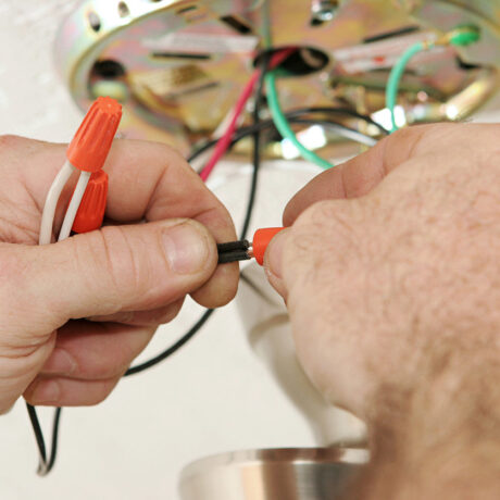 A person repairing wiring connections