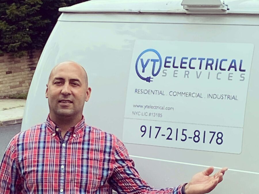 A person standing near an electric service truck